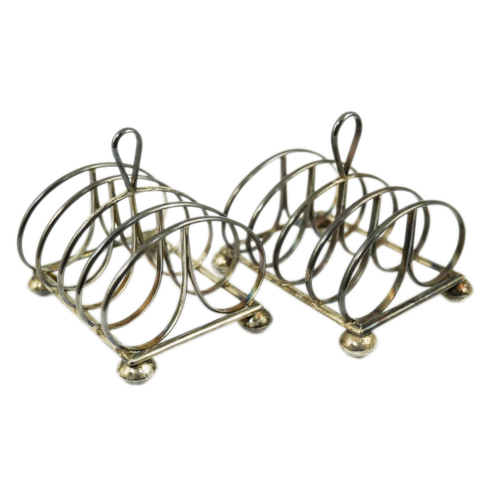 A pair of Elizabeth II silver five bar toastracks by Simone Genevieve Rutherford, with loop handle, on ball feet, London, 1991, length 11cm, 10.1oz. Condition - good